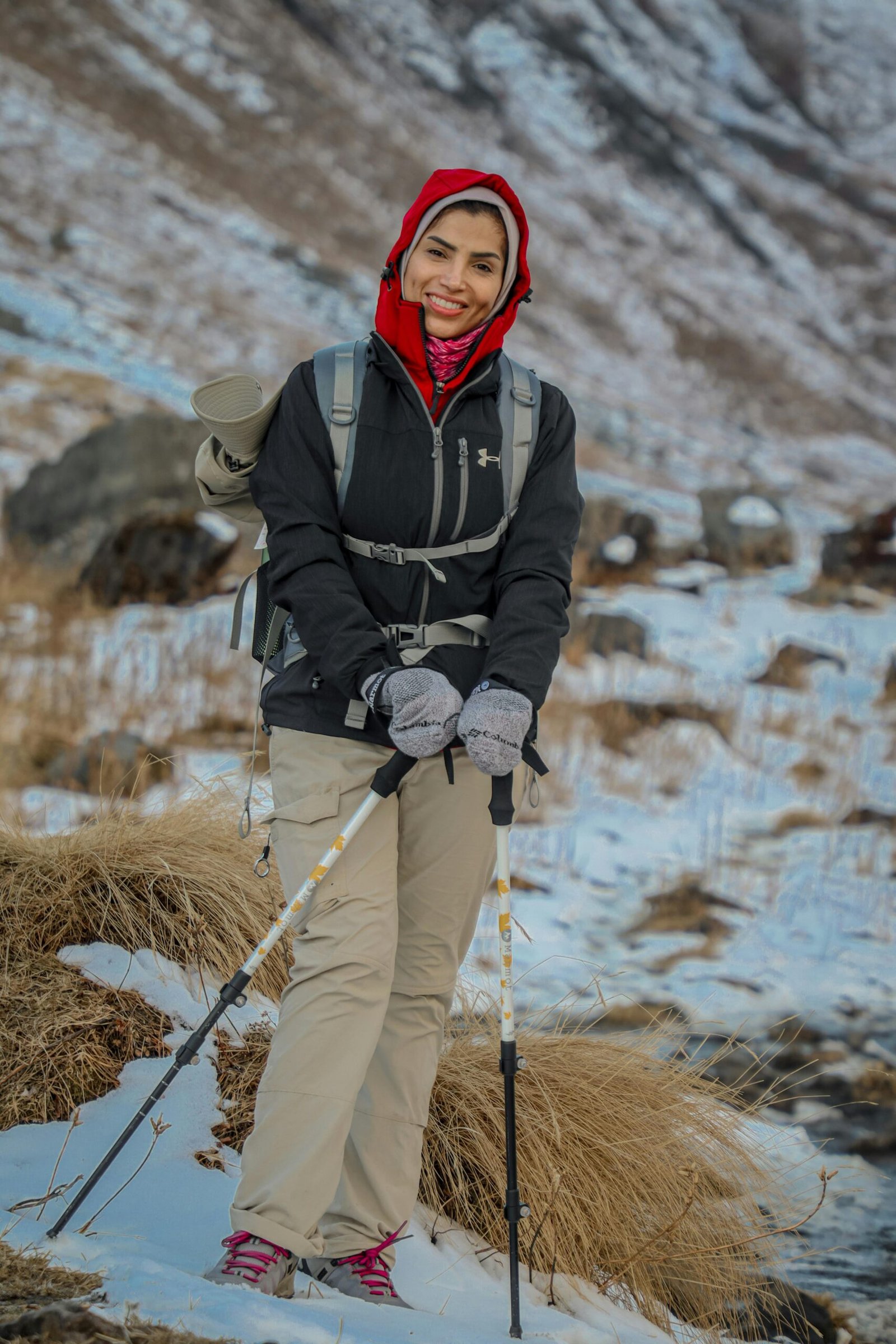 Woman enjoying a winter hike in Annapurna, Nepal with snow-covered mountains.